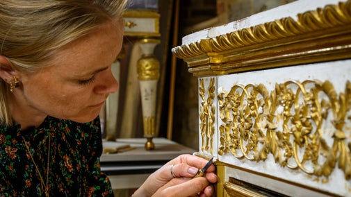 A conservator works on a royal Sardinian chest from Attingham Park, Shropshire